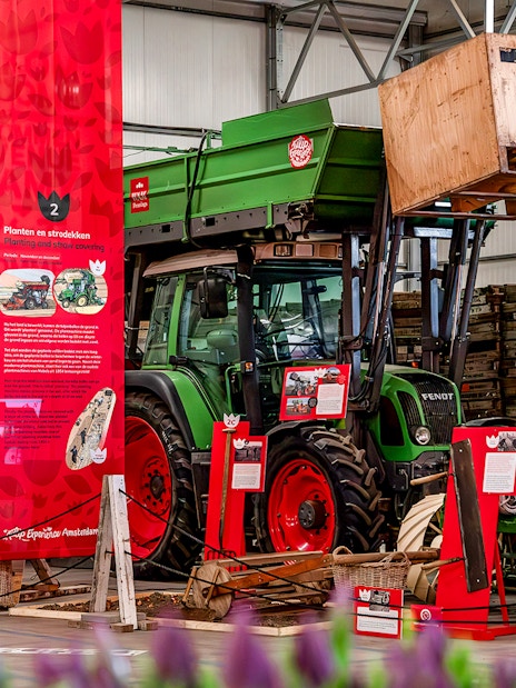 Exhibition display with tractor and informational panels at Keukenhof.