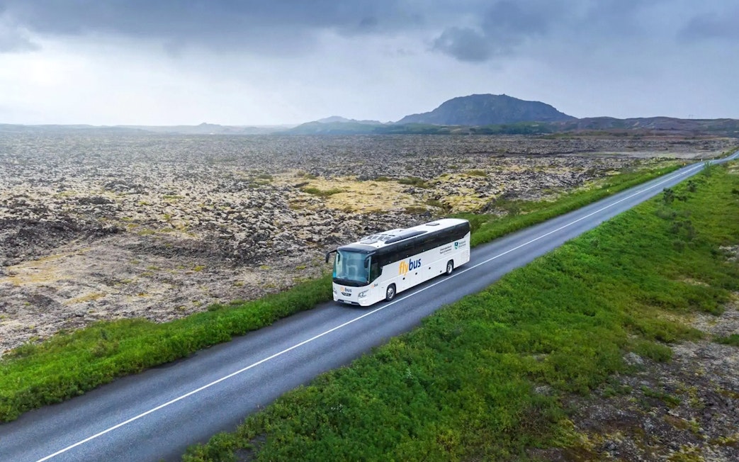 Bus traveling through Icelandic landscape