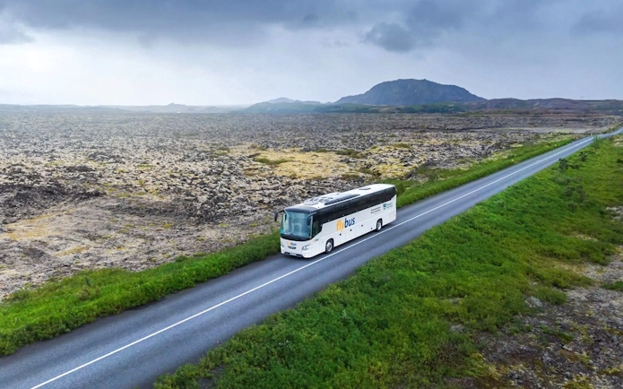 Bus traveling through Icelandic landscape