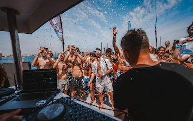 Tourists enjoying music and dancing on a Cruise Crush Boat Party.