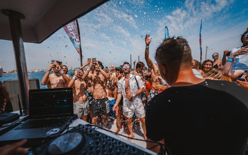 Tourists enjoying music and dancing on a Cruise Crush Boat Party.
