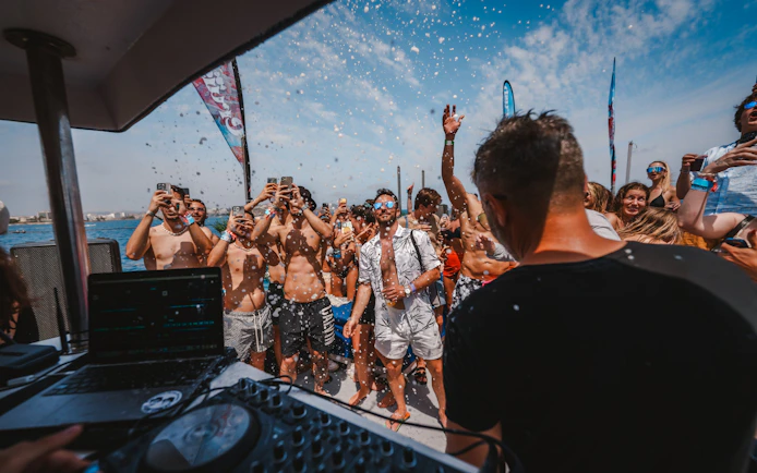 Tourists enjoying music and dancing on a Cruise Crush Boat Party.