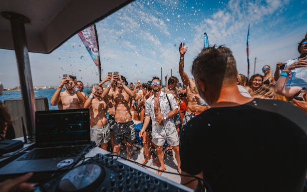 Tourists enjoying music and dancing on a Cruise Crush Boat Party.