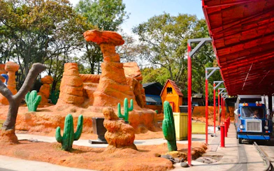 ACME Trucking Company ride at Six Flags Mexico with desert-themed landscape.