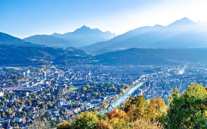 Hungerburg view of Innsbruck cityscape with mountains and river.
