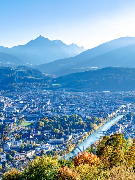 Hungerburg view of Innsbruck cityscape with mountains and river.