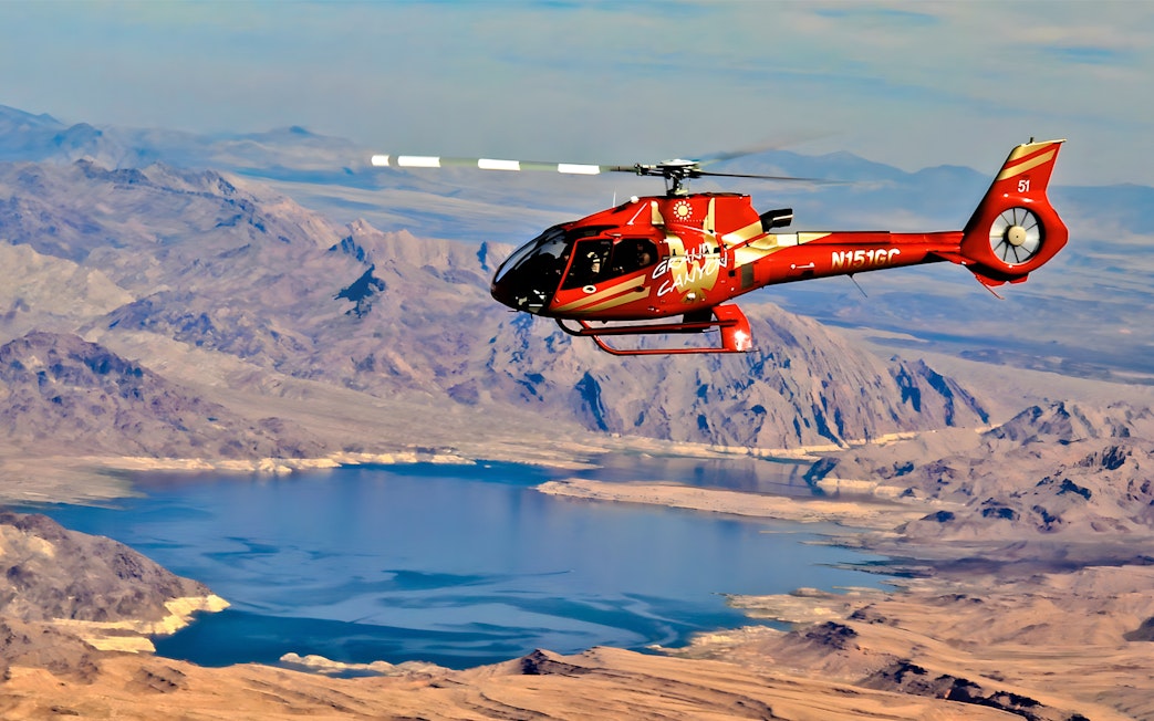 Helicopter flying over the Grand Canyon West Rim with Lake Mead in view.