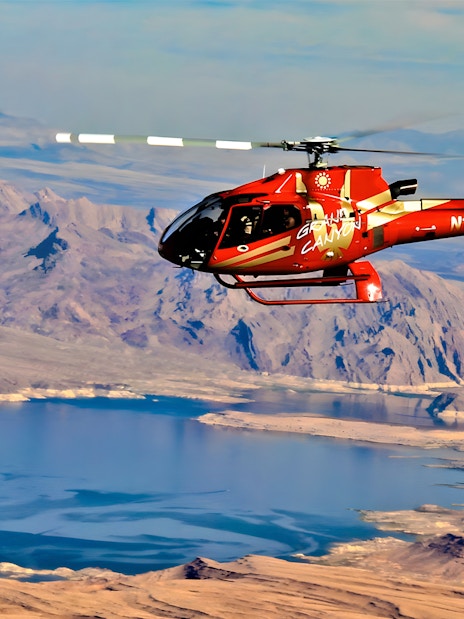Helicopter flying over the Grand Canyon West Rim with Lake Mead in view.