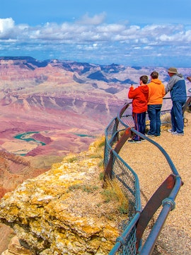 Visitors at a Grand Canyon overlook with expansive canyon views.