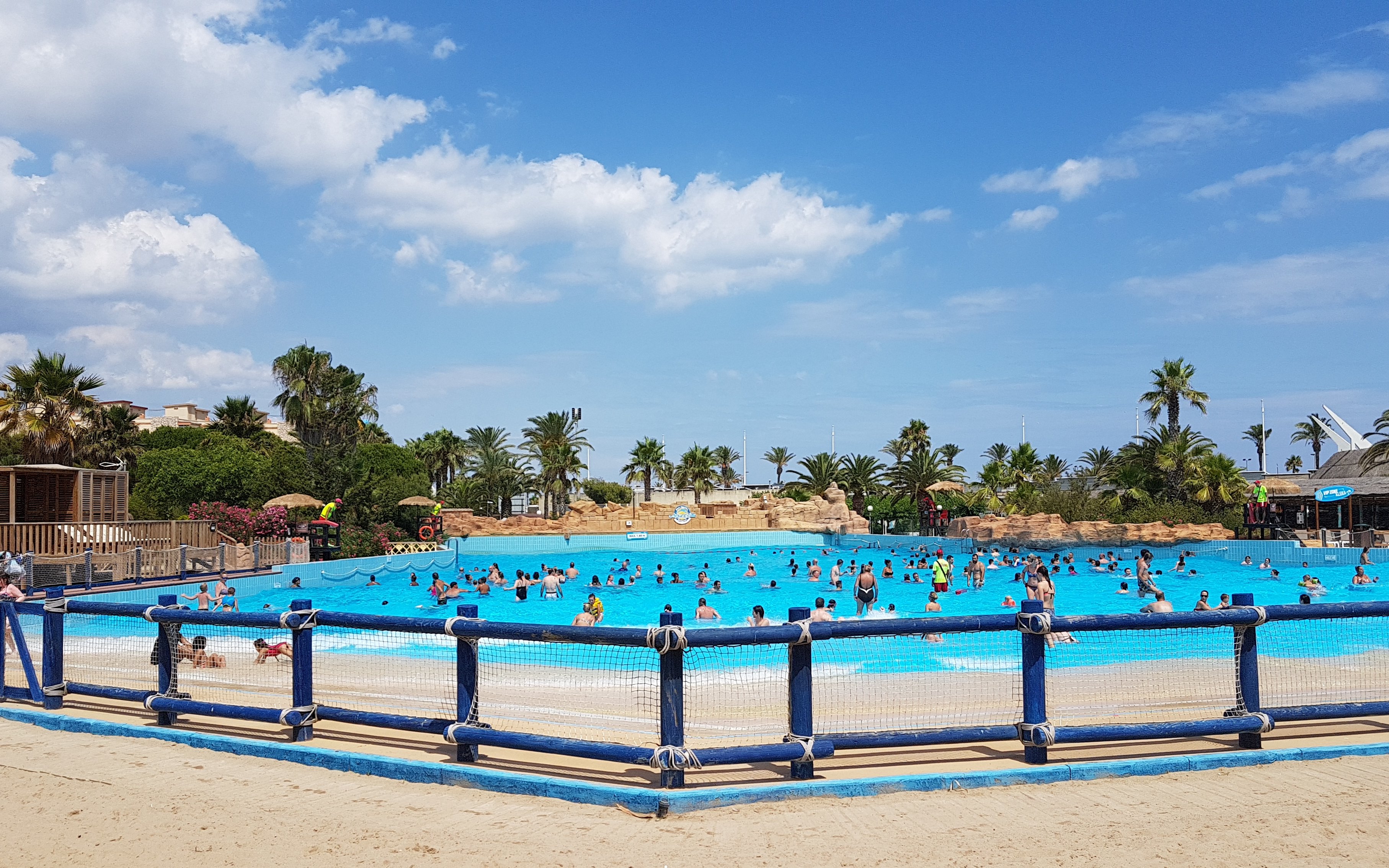 Visitors enjoying the wave pool at Aquopolis Costa Daurada, Tarragona.