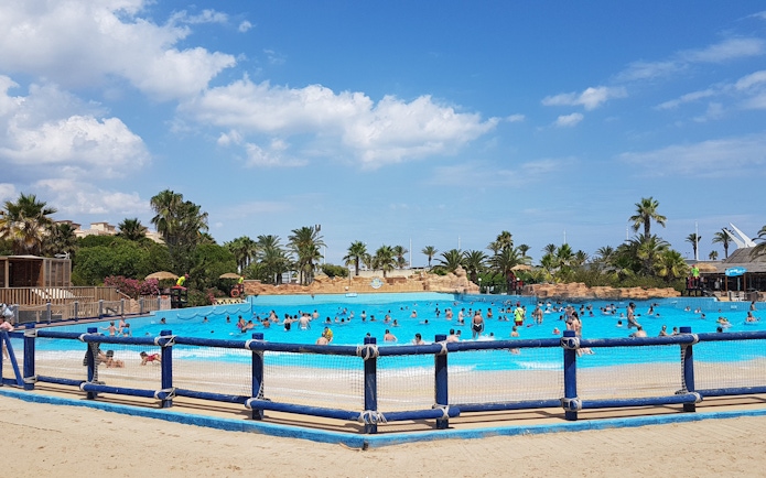 Visitors enjoying the wave pool at Aquopolis Costa Daurada, Tarragona.