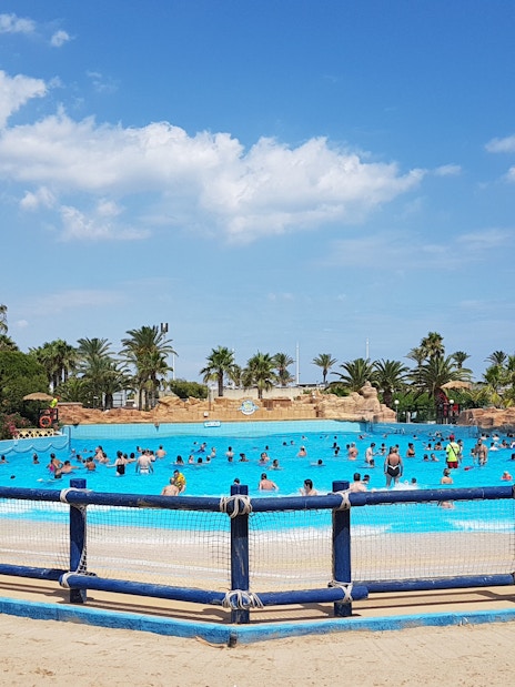 Visitors enjoying the wave pool at Aquopolis Costa Daurada, Tarragona.