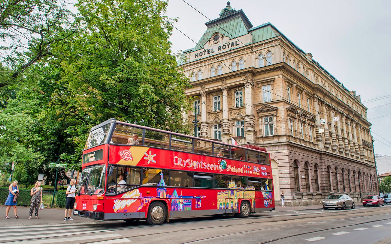 Krakow hop-on hop-off bus passing Hotel Royal on a city tour.