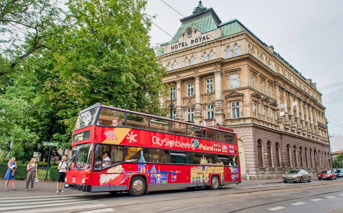 Krakow hop-on hop-off bus passing Hotel Royal on a city tour.
