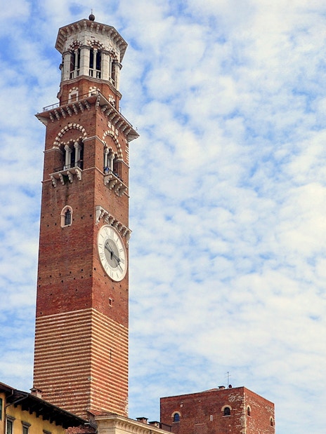 Torre dei Lamberti in Verona, Italy, under a cloudy sky.