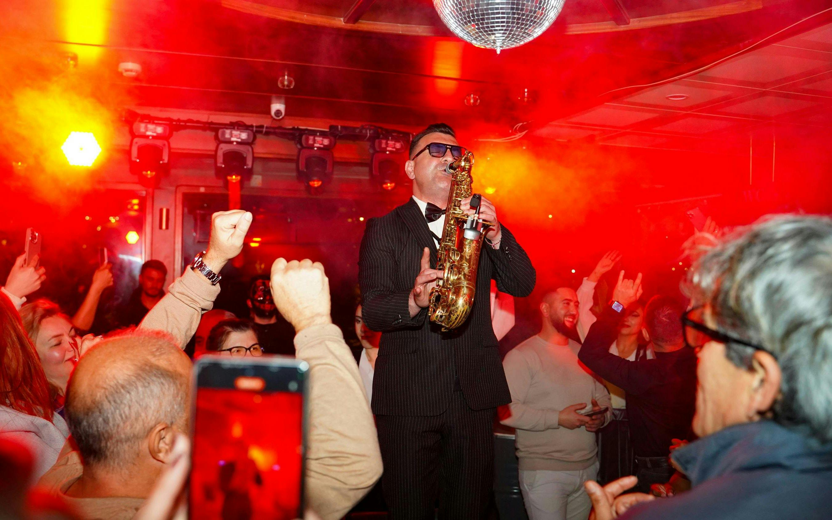 Saxophonist performing on Luxury Bosphorus Dinner Cruise at night.