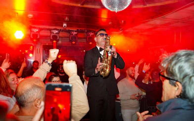 Saxophonist performing on Luxury Bosphorus Dinner Cruise at night.