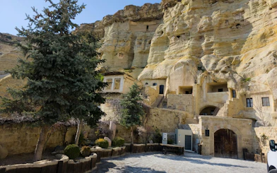 Rock-cut dwellings and trees in Avanos, Cappadocia.