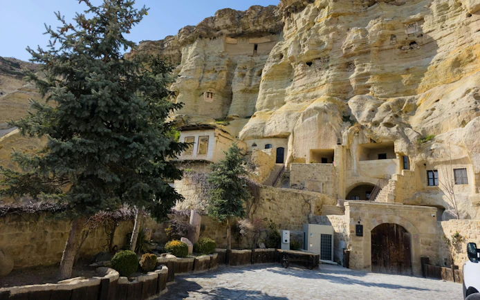 Rock-cut dwellings and trees in Avanos, Cappadocia.