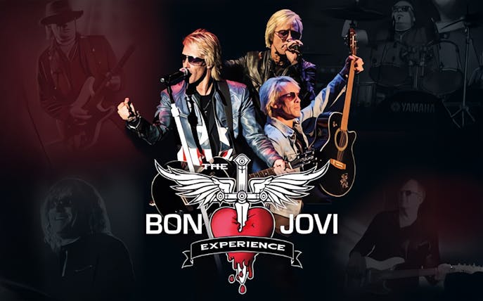 Band performing on stage with "The Bon Jovi Experience" logo in the foreground.