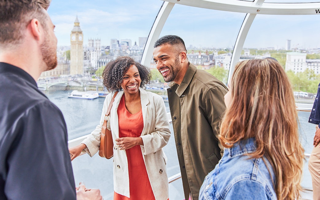 Group enjoying view of Big Ben from London Eye capsule.