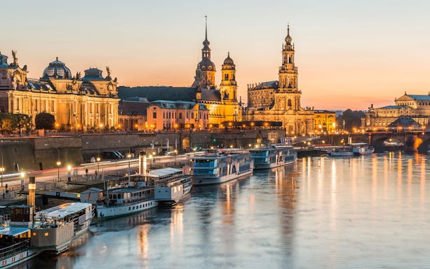 Dresden skyline at sunset with historic buildings and Elbe River, Germany.