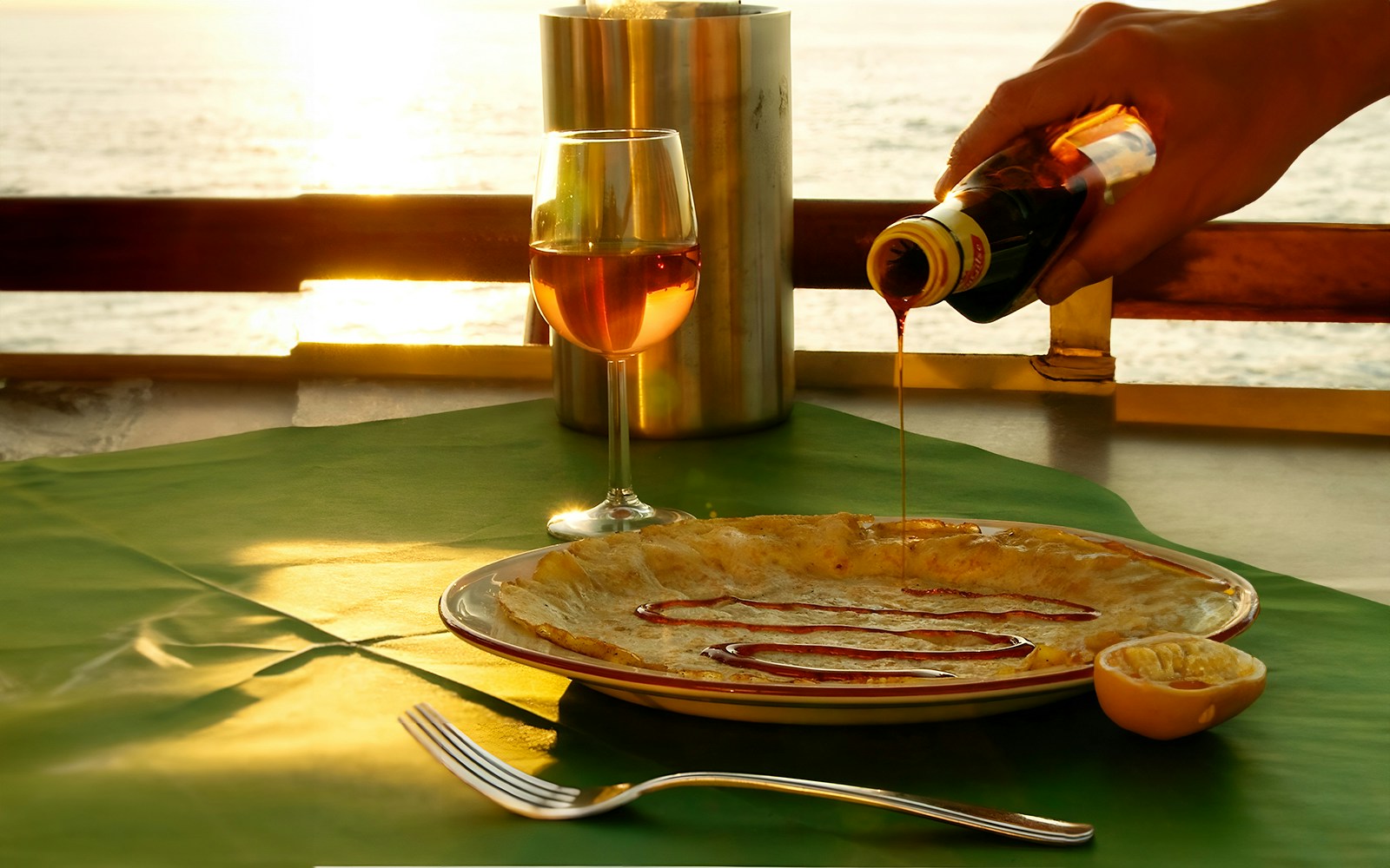 Passengers enjoying a Pancake Cruise in Amsterdam, with a scenic view of the city's historic canals and architecture