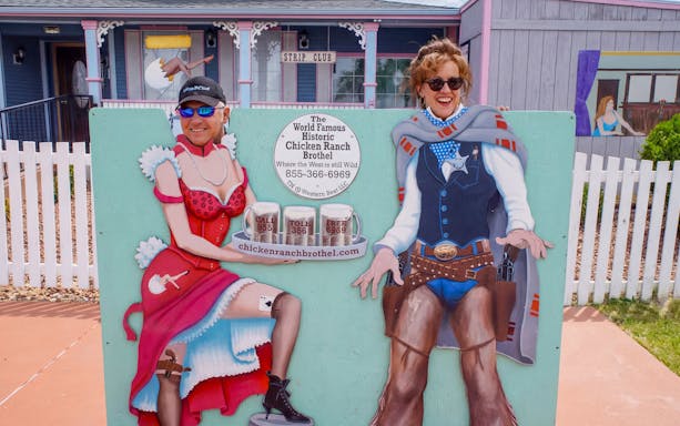Guests posing with cutout at Chicken Ranch, Nevada.