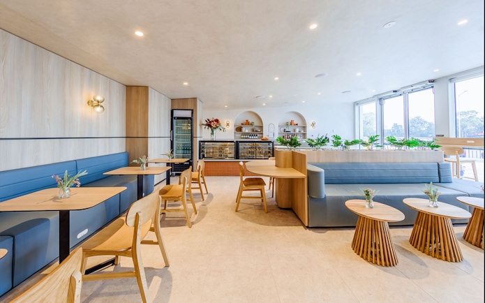 Plaza Premium Lounge seating area with tables and chairs, International Arrival.