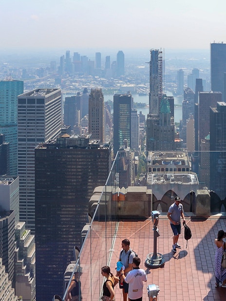 Visitors enjoying the view from Top of the Rock Observation Deck in New York City.