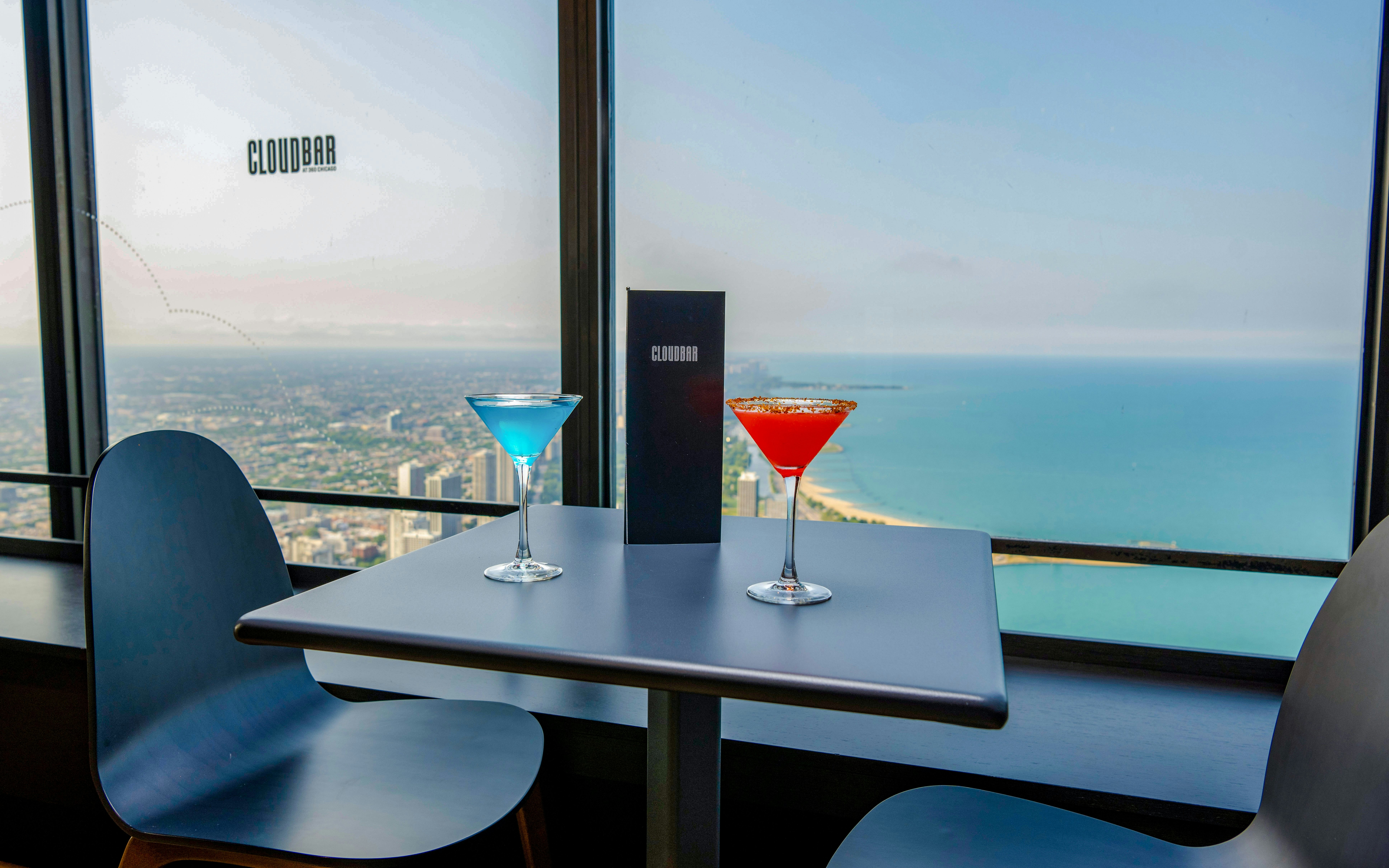 Cocktails on a table with a view of Lake Michigan at Cloud Bar, Chicago 360.
