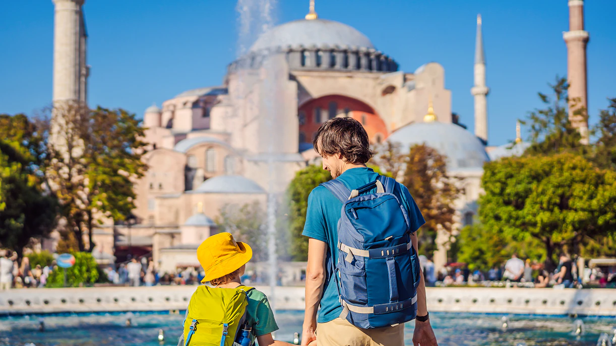 Father and son holding hands in Hagia Sophia gardens, Istanbul.