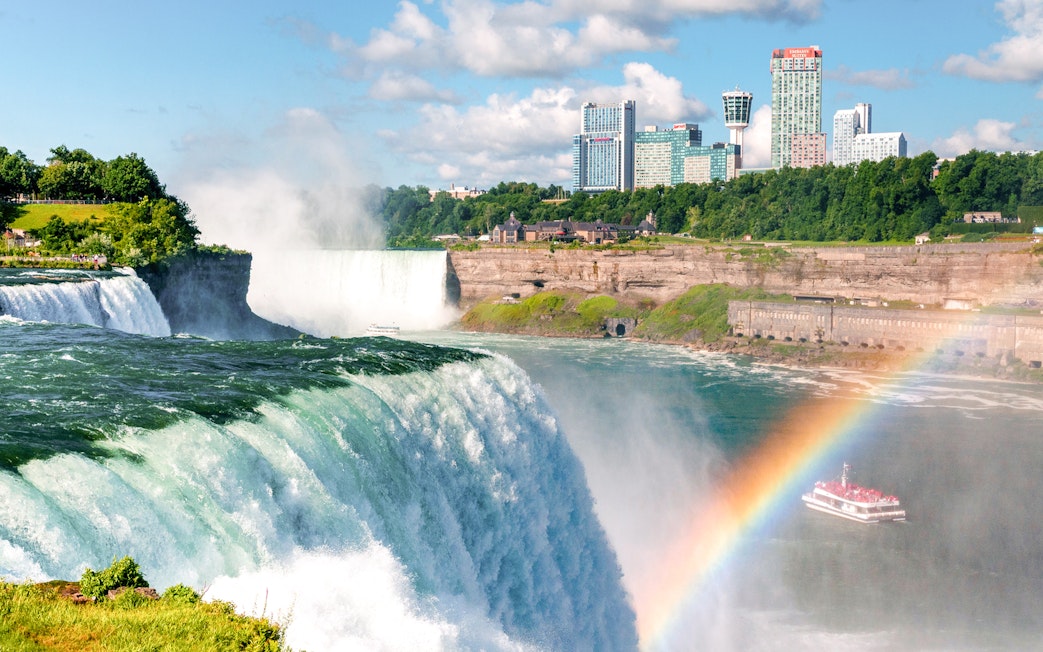 Niagara Falls boat tour with mist and rainbow, Canada.