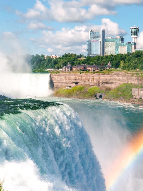 Niagara Falls boat tour with mist and rainbow, Canada.