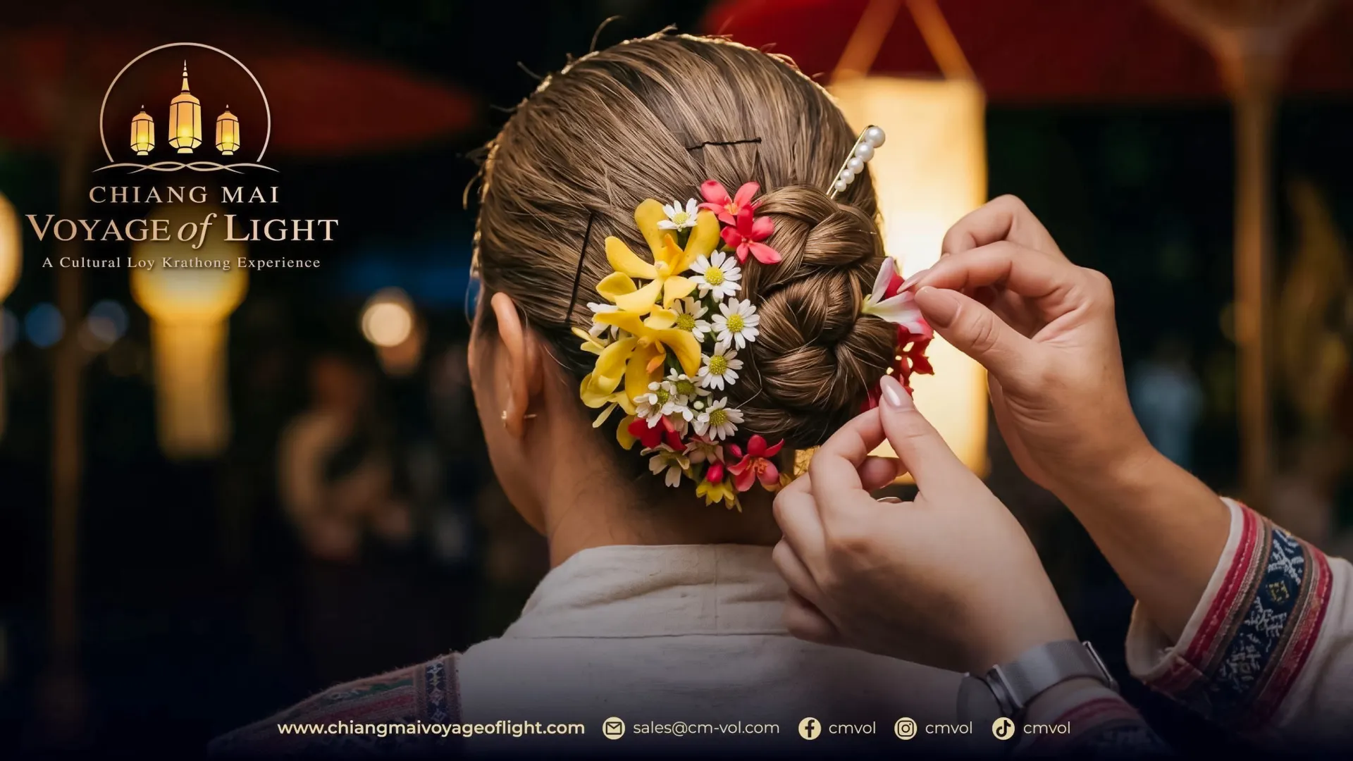 Woman's hair adorned with colorful flowers during Chiang Mai Voyage of Light festival.
