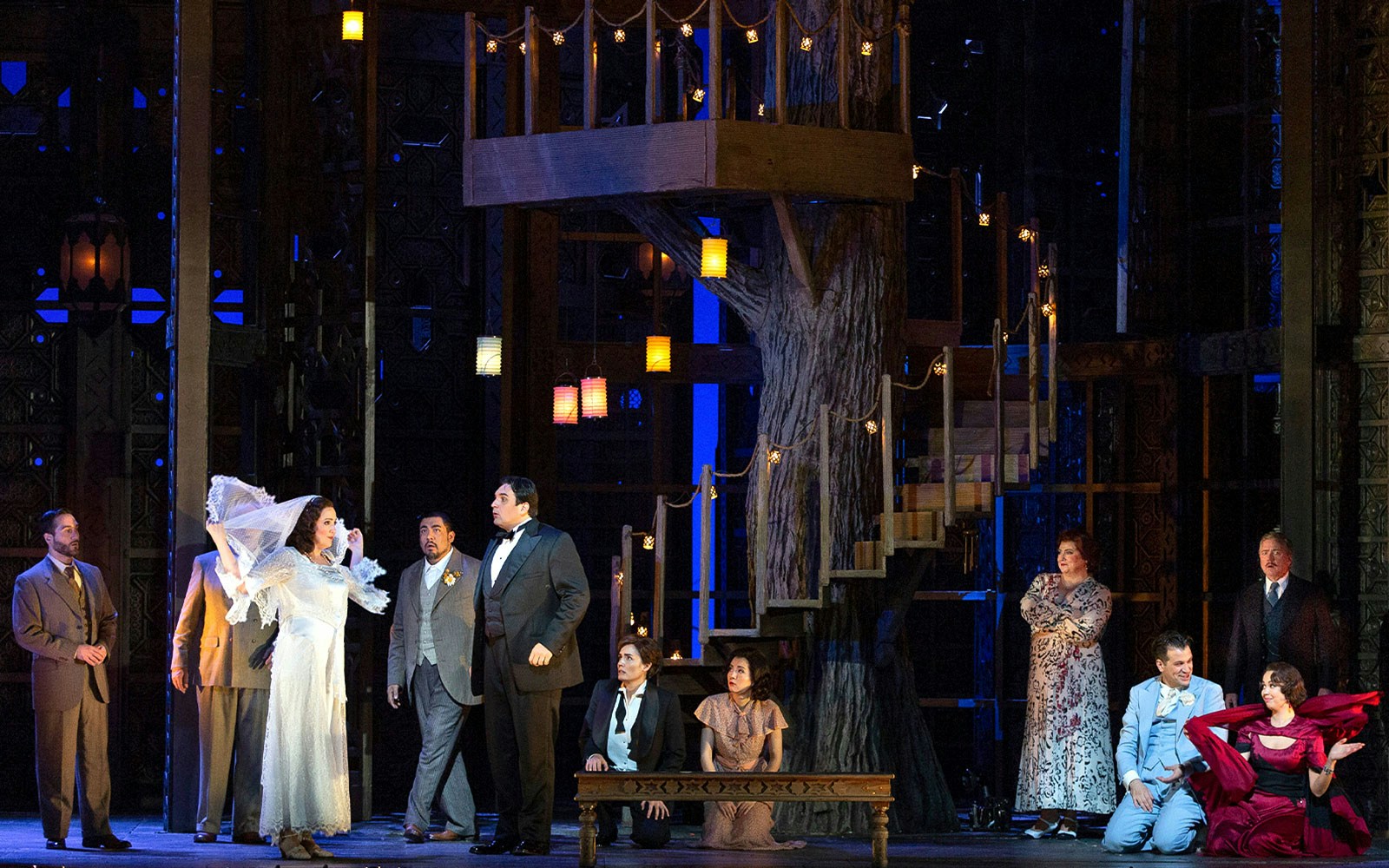 Opera performance of Le Nozze Di Figaro with cast on stage, featuring a treehouse set.