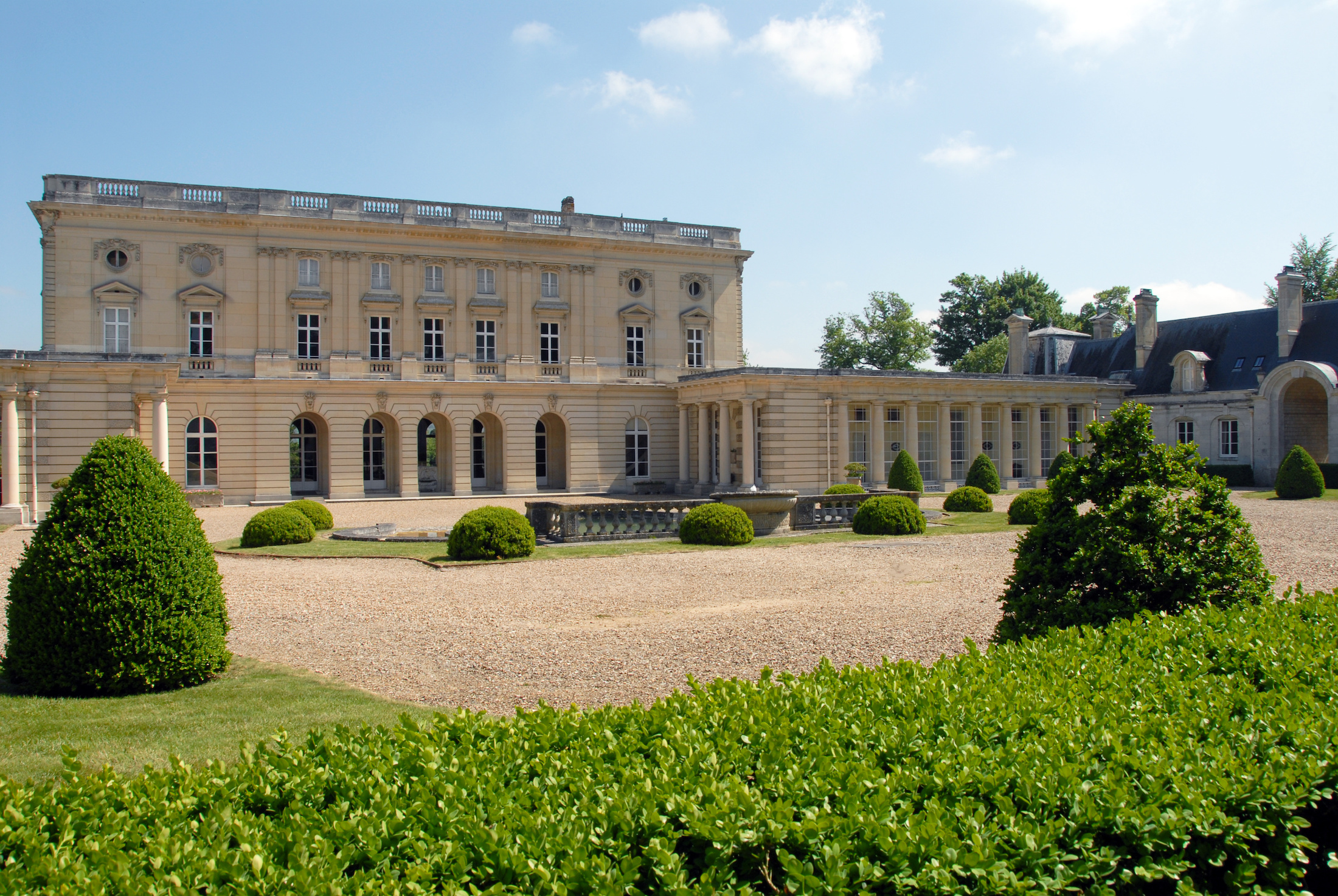 Château de Bizy exterior with lush gardens in Vernon, France.