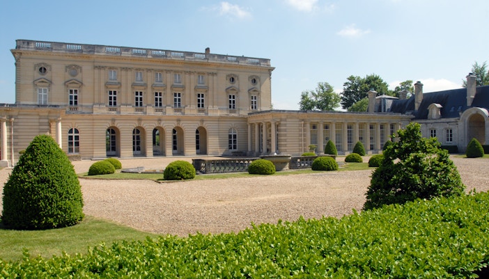 Château de Bizy exterior with lush gardens in Vernon, France.