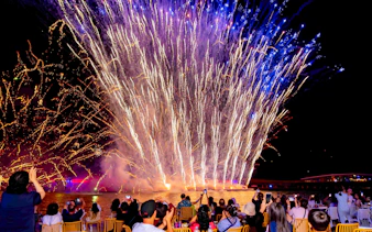 Fireworks display over water during Phu Quoc Sunset Tour with audience watching.
