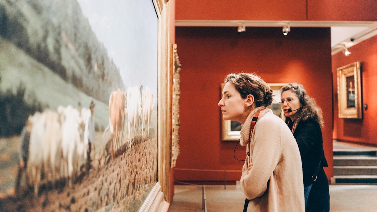 Woman observing painting at Orsay Museum, Paris, France.