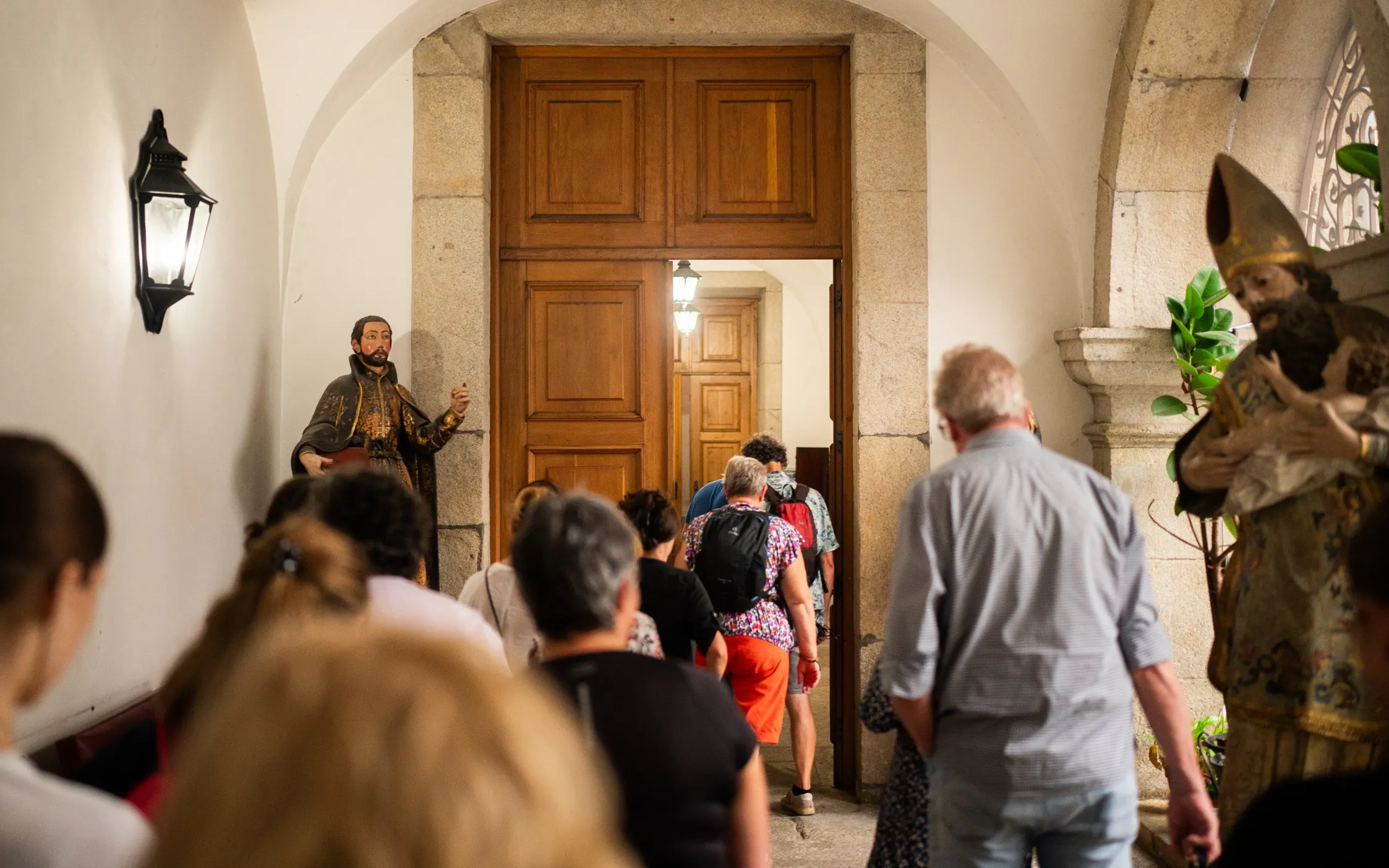Visitors entering the Monastery of São Bento da Vitória in Porto during a guided tour.