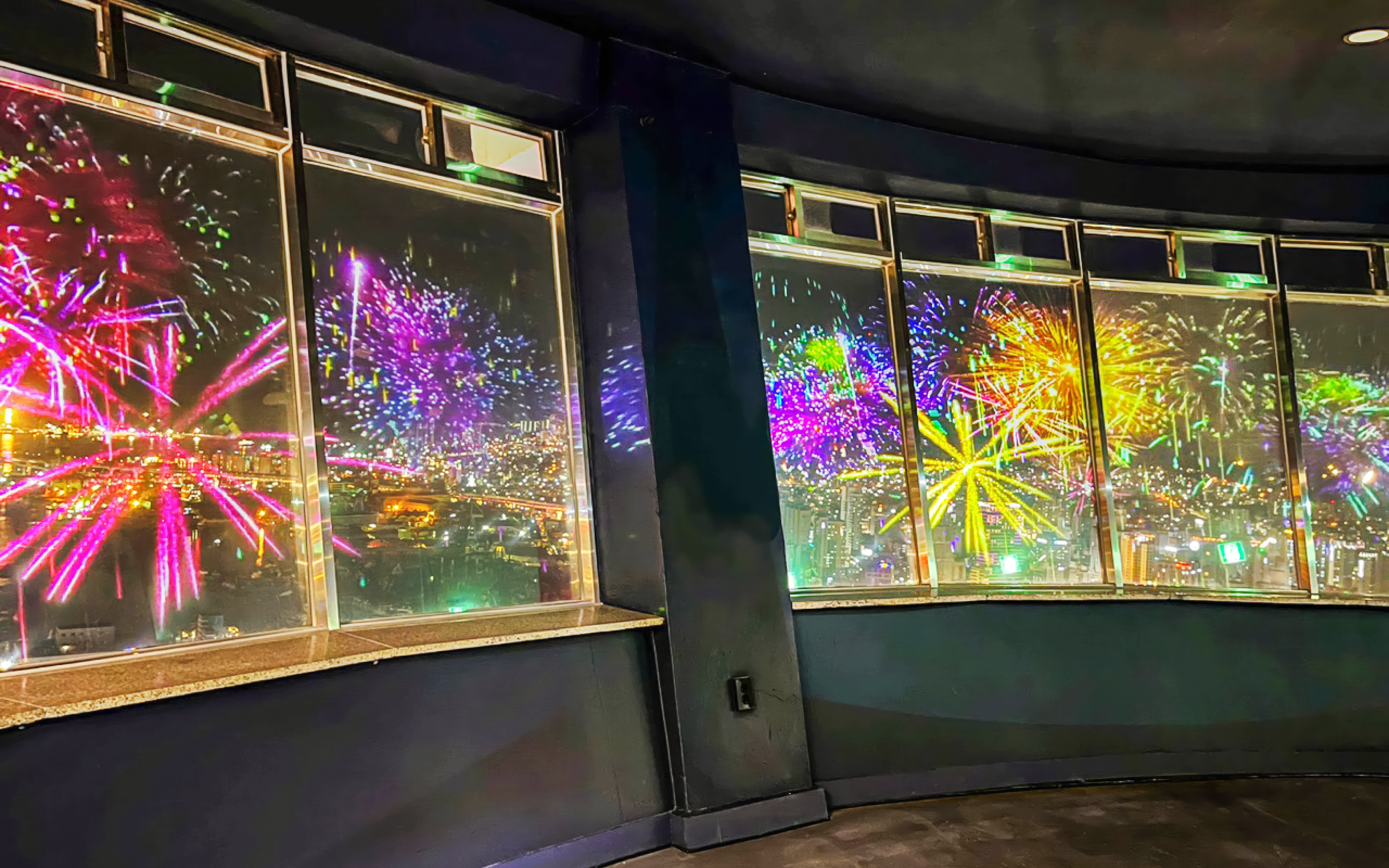 Fireworks display viewed from Busan Tower observatory at night.