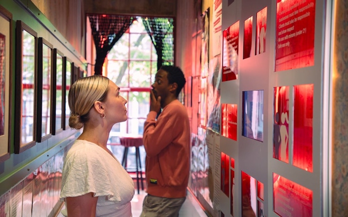 Visitors exploring exhibits at Red Light Secrets Museum in Amsterdam.