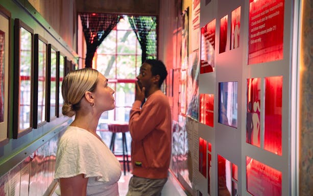 Visitors exploring exhibits at Red Light Secrets Museum in Amsterdam.