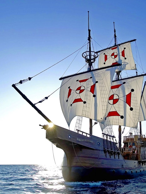 Sailing ship on Elaphite Islands cruise under clear blue sky.