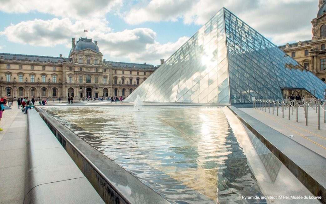 Louvre Museum glass pyramid and courtyard in Paris, France.