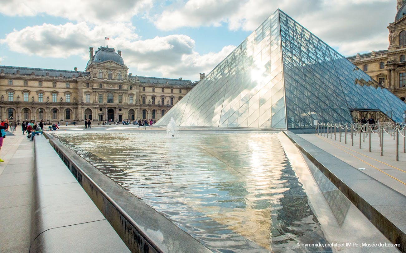 Louvre Museum glass pyramid and courtyard in Paris, France.
