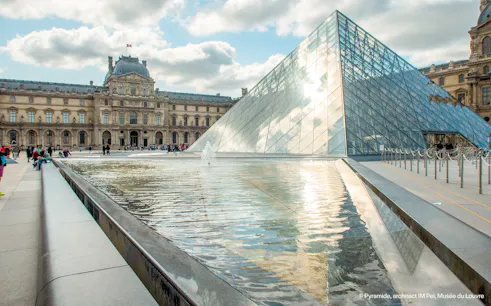 Louvre Museum glass pyramid and courtyard in Paris, France.