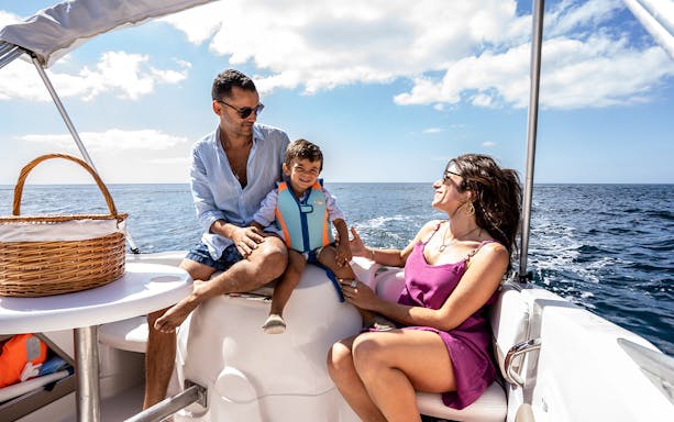 Family enjoying a boat ride on a sunny day, highlighting half day or full day boat rental experience.
