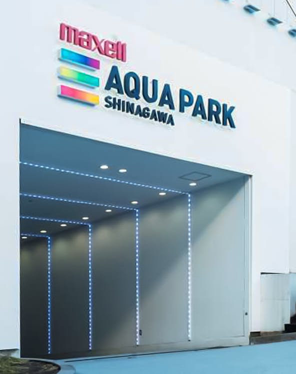 Entrance to Maxell Aqua Park Shinagawa with illuminated signage.